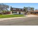 Charming home with lush lawn, mature trees, and attached garage at 5203 Scranton St, Denver, CO 80239