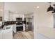 Well-equipped kitchen featuring stainless steel appliances, white cabinets, and a stylish design with modern lighting at 5203 Scranton St, Denver, CO 80239