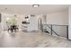 Open-concept living area featuring sleek flooring, modern railings, and a bright dining area with a stylish kitchen at 5203 Scranton St, Denver, CO 80239