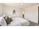Comfortable main bedroom with soft carpeting, neutral tones, and an ensuite bathroom with natural light at 5203 Scranton St, Denver, CO 80239