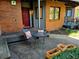 Exterior patio view with seating, brickwork, red door, and landscaping at 1633 18Th St St # 2, Boulder, CO 80302