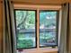 View from inside, revealing a tranquil stream and lush greenery outside the window at 1633 18Th St St # 2, Boulder, CO 80302