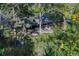 An aerial view of a backyard featuring mature trees, a patio with outdoor furniture, and lush greenery at 5795 Oak Creek Ln, Greenwood Village, CO 80121