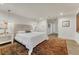 Comfortable bedroom featuring a large bed, soft lighting, and access to the ensuite bathroom at 5795 Oak Creek Ln, Greenwood Village, CO 80121