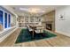 An elegant dining area featuring a fireplace, a large window, and a wall of built-in bookshelves at 5795 Oak Creek Ln, Greenwood Village, CO 80121
