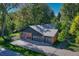 Aerial view of a well-maintained single-Gathering home, featuring an attached garage and beautiful landscaping at 5795 Oak Creek Ln, Greenwood Village, CO 80121