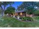 Charming brick home with mature trees, a well manicured lawn and professionally landscaped yard at 5795 Oak Creek Ln, Greenwood Village, CO 80121