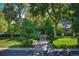 Charming home with a well-manicured lawn, mature trees, and inviting front entrance at 5795 Oak Creek Ln, Greenwood Village, CO 80121