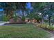 Landscaped front yard with mature trees and lush green lawn at 5795 Oak Creek Ln, Greenwood Village, CO 80121