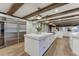 Gourmet kitchen features an oversized island, stainless steel fridge, and ample counter space at 5795 Oak Creek Ln, Greenwood Village, CO 80121