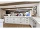 Spacious kitchen features a large island, white cabinets, and modern appliances at 5795 Oak Creek Ln, Greenwood Village, CO 80121