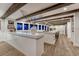 Modern kitchen featuring a large island, exposed beams, and sleek countertops at 5795 Oak Creek Ln, Greenwood Village, CO 80121