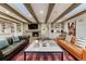 Large living room boasts a fireplace, wood beams, stylish decor, and comfortable seating at 5795 Oak Creek Ln, Greenwood Village, CO 80121