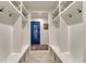 Organized mudroom with built-in storage cubbies, hooks, and seating, offering a practical entryway at 5795 Oak Creek Ln, Greenwood Village, CO 80121