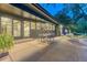 Lovely patio area with dining table and chairs, adjacent to the house and the large backyard at 5795 Oak Creek Ln, Greenwood Village, CO 80121