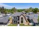 Eye-catching aerial view of a modern home with a manicured lawn, and a peek of the city skyline in the distance at 2540 Jay St, Edgewater, CO 80214