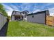 Spacious backyard featuring a lush lawn, outdoor patio, and detached garage, perfect for relaxation and activities at 2540 Jay St, Edgewater, CO 80214