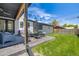 Well-maintained backyard with a cozy patio area, green lawn, and detached garage; great for outdoor living at 2540 Jay St, Edgewater, CO 80214