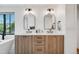 A stylish bathroom is adorned with double sinks, sleek hardware and fixtures, and streamlined counters at 2540 Jay St, Edgewater, CO 80214