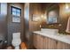 Stylish bathroom with a modern vanity, unique lighting, and dark brown walls at 2540 Jay St, Edgewater, CO 80214