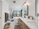 Sleek bathroom featuring dual vanities, walk-in shower, soaking tub, large window, and modern fixtures at 2540 Jay St, Edgewater, CO 80214