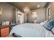 Comfortable bedroom showing a well-made bed, modern lighting fixture, and access to an en-suite bathroom at 2540 Jay St, Edgewater, CO 80214