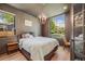 Cozy bedroom featuring a comfortable bed, stylish lighting, and windows that offer a pleasant outdoor view at 2540 Jay St, Edgewater, CO 80214