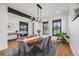 Elegant dining room featuring hardwood floors, a modern chandelier, and views into the bedroom and living areas at 2540 Jay St, Edgewater, CO 80214