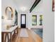 Inviting home entryway showcasing hardwood floors, a console table, and an elegant mirror that sets a warm tone at 2540 Jay St, Edgewater, CO 80214