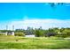 Scenic community view featuring a bridge, lake, and city skyline under a clear blue sky at 2540 Jay St, Edgewater, CO 80214