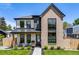 Charming two-story home featuring a modern exterior with a brick facade, well-manicured lawn, and covered porch at 2540 Jay St, Edgewater, CO 80214