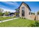 Beautiful two-story home featuring modern design, lush lawn, inviting walkway, and a detached garage on the property at 2540 Jay St, Edgewater, CO 80214
