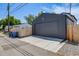 Exterior view of a well-maintained garage with a gray door, concrete driveway and wooden fence at 2540 Jay St, Edgewater, CO 80214