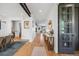 Spacious hallway with light hardwood floors, modern lighting, and an open layout leading to the dining and living areas at 2540 Jay St, Edgewater, CO 80214