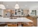Modern kitchen featuring a large island with seating, stainless appliances, and stylish wood cabinetry at 2540 Jay St, Edgewater, CO 80214