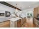 Bright, open kitchen with island, stainless appliances, and view into the dining and living areas at 2540 Jay St, Edgewater, CO 80214