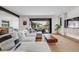Cozy living room with a large sectional sofa, hardwood floors, and sliding glass doors to the patio at 2540 Jay St, Edgewater, CO 80214