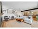 Open-concept living area with a staircase, modern fireplace, and hardwood floors flowing into the kitchen at 2540 Jay St, Edgewater, CO 80214