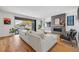 Inviting living room featuring a modern fireplace, hardwood floors, and access to the backyard patio at 2540 Jay St, Edgewater, CO 80214