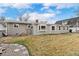 Spacious backyard featuring a grassy area and the back of the home at 12223 W 60Th Pl, Arvada, CO 80004