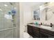 Modern bathroom with glass enclosed shower, granite countertop and ample cabinet space at 12223 W 60Th Pl, Arvada, CO 80004