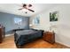 Bedroom featuring hardwood floors, a modern ceiling fan, and ample natural light at 12223 W 60Th Pl, Arvada, CO 80004