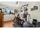 Home gym with exercise machines, weights, ceiling fan, and bright windows at 12223 W 60Th Pl, Arvada, CO 80004