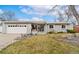 Ranch-style home with a two car garage, landscaped lawn, and neutral exterior at 12223 W 60Th Pl, Arvada, CO 80004