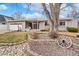 Charming ranch home with a well-manicured front yard and inviting entrance at 12223 W 60Th Pl, Arvada, CO 80004