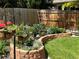 Landscaped backyard with raised garden beds and flowers at 13735 Steele Ct, Thornton, CO 80602