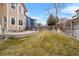 Fenced backyard with grass, patio, and rock borders at 13735 Steele Ct, Thornton, CO 80602