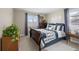 Serene bedroom with a dark wood bed frame and stylish decor at 13735 Steele Ct, Thornton, CO 80602