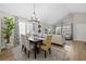 Elegant dining area with a wooden table, chandelier, and hardwood floors at 13735 Steele Ct, Thornton, CO 80602