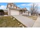 Two-story house with a beige exterior, front porch, and attached garage at 13735 Steele Ct, Thornton, CO 80602